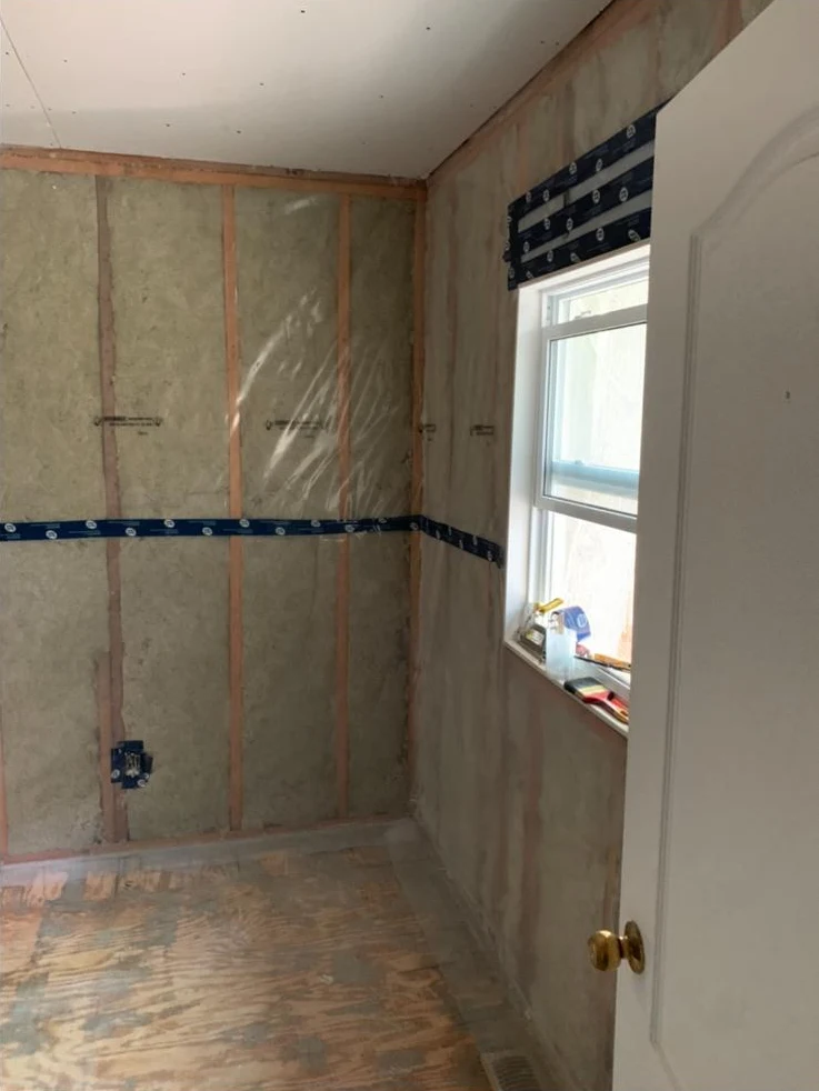 Window, insulation and vapour barrier in a room being renovated